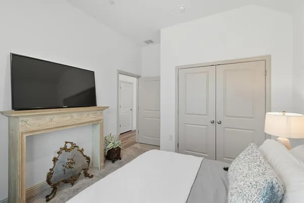 a bedroom with a flat screen tv and a bed