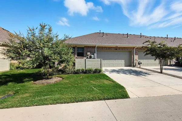 a backyard of a house with plants and tree