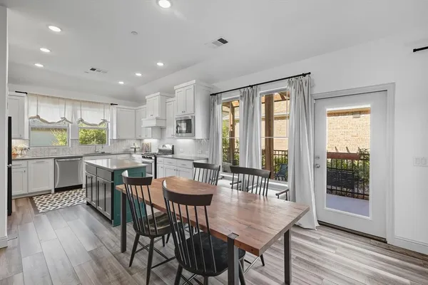 a kitchen with a sink stove and microwave