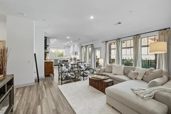 a living room with furniture and large windows