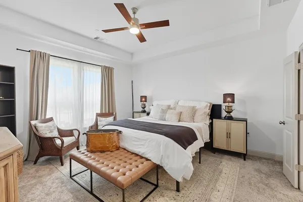 a bedroom with a bed and a chandelier