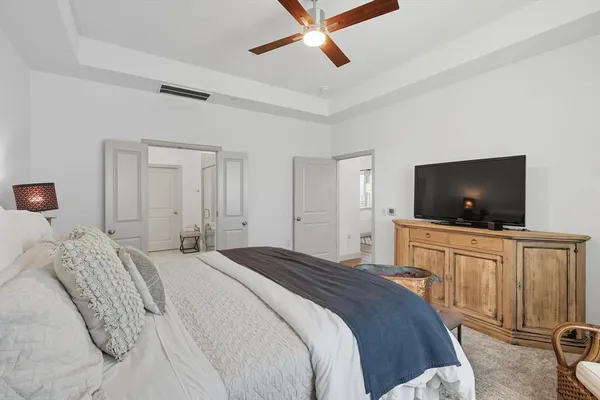 a bedroom with a large bed and a flat screen tv