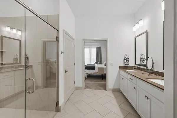 a spacious bathroom with a granite countertop sink mirror and shower