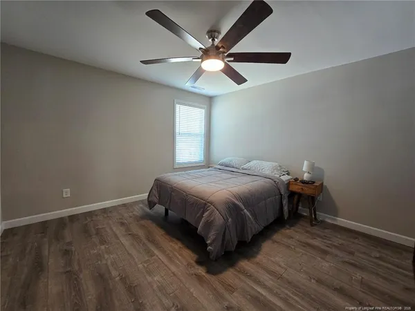 a bedroom with a bed and window