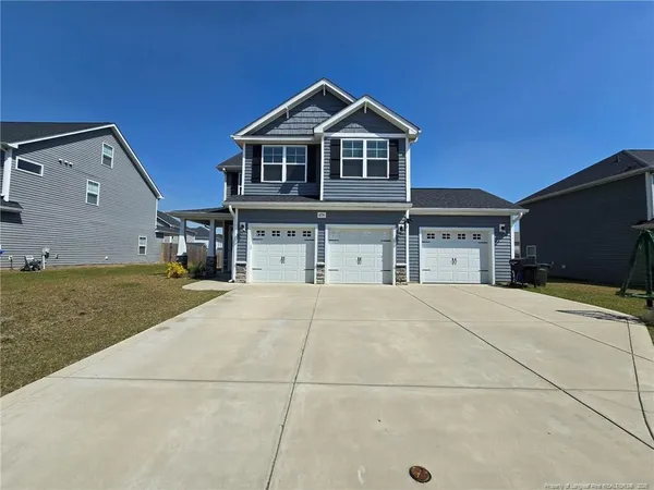 a front view of a house with a yard and garage