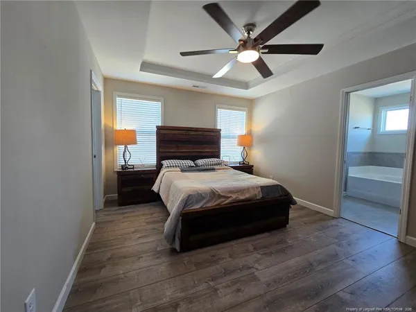 a bedroom with a bed and a ceiling fan