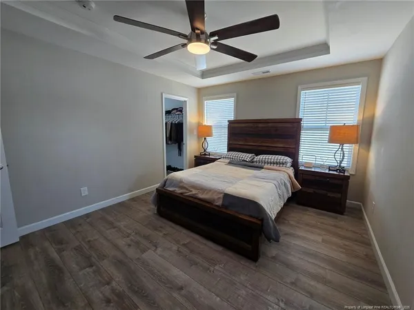 a bedroom with a bed and a ceiling fan