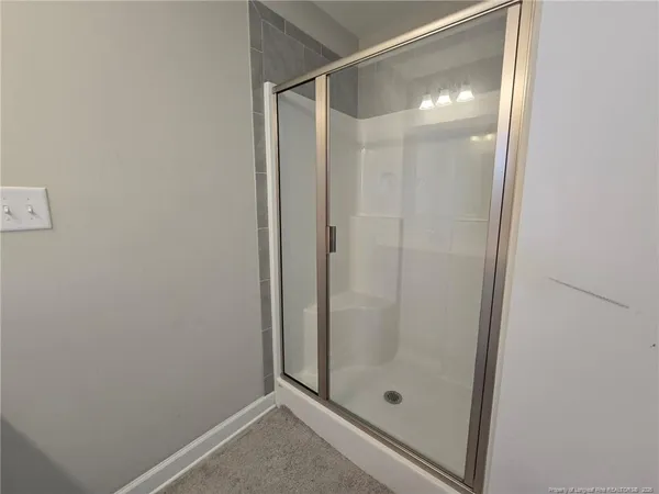 a bathroom with a glass shower door