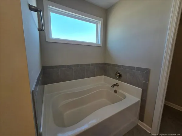 a white bath tub sitting in a bathroom