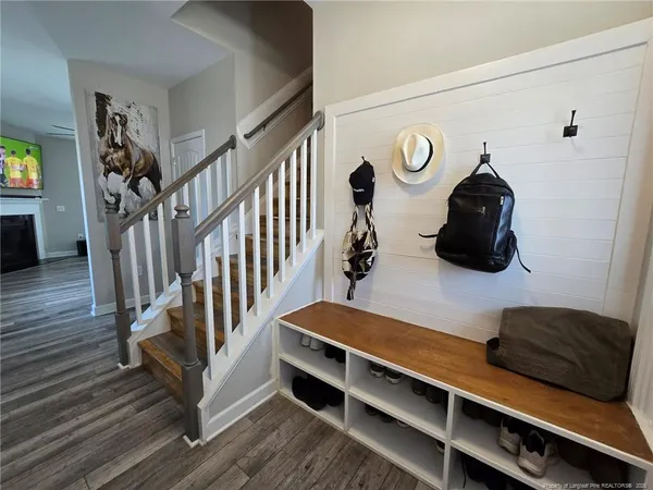 a view of entryway and hall with wooden floor