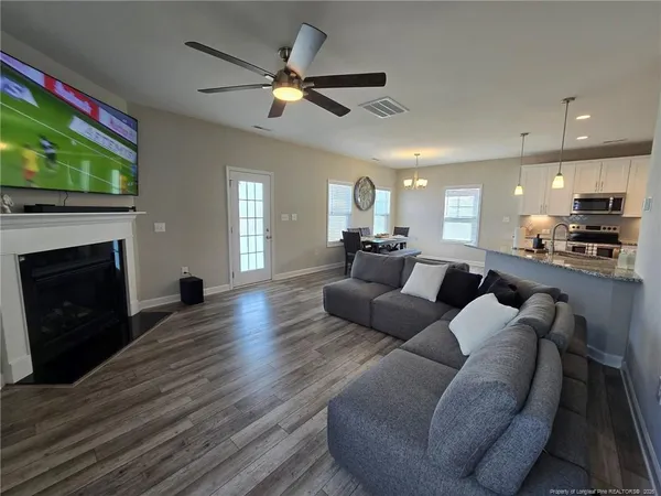 a living room with furniture and a fireplace