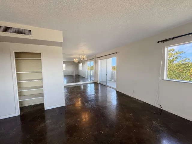 a view of a room with wooden floor and window