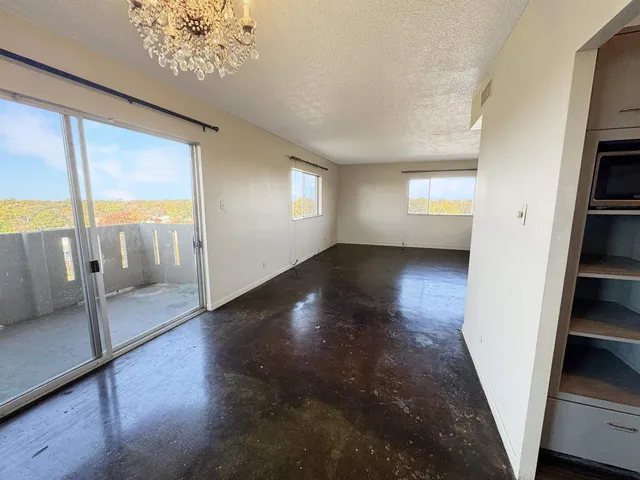 a view of a hallway with wooden floor and stairs
