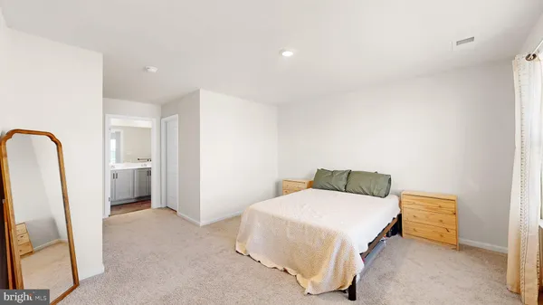 a bedroom with a bed and a sink