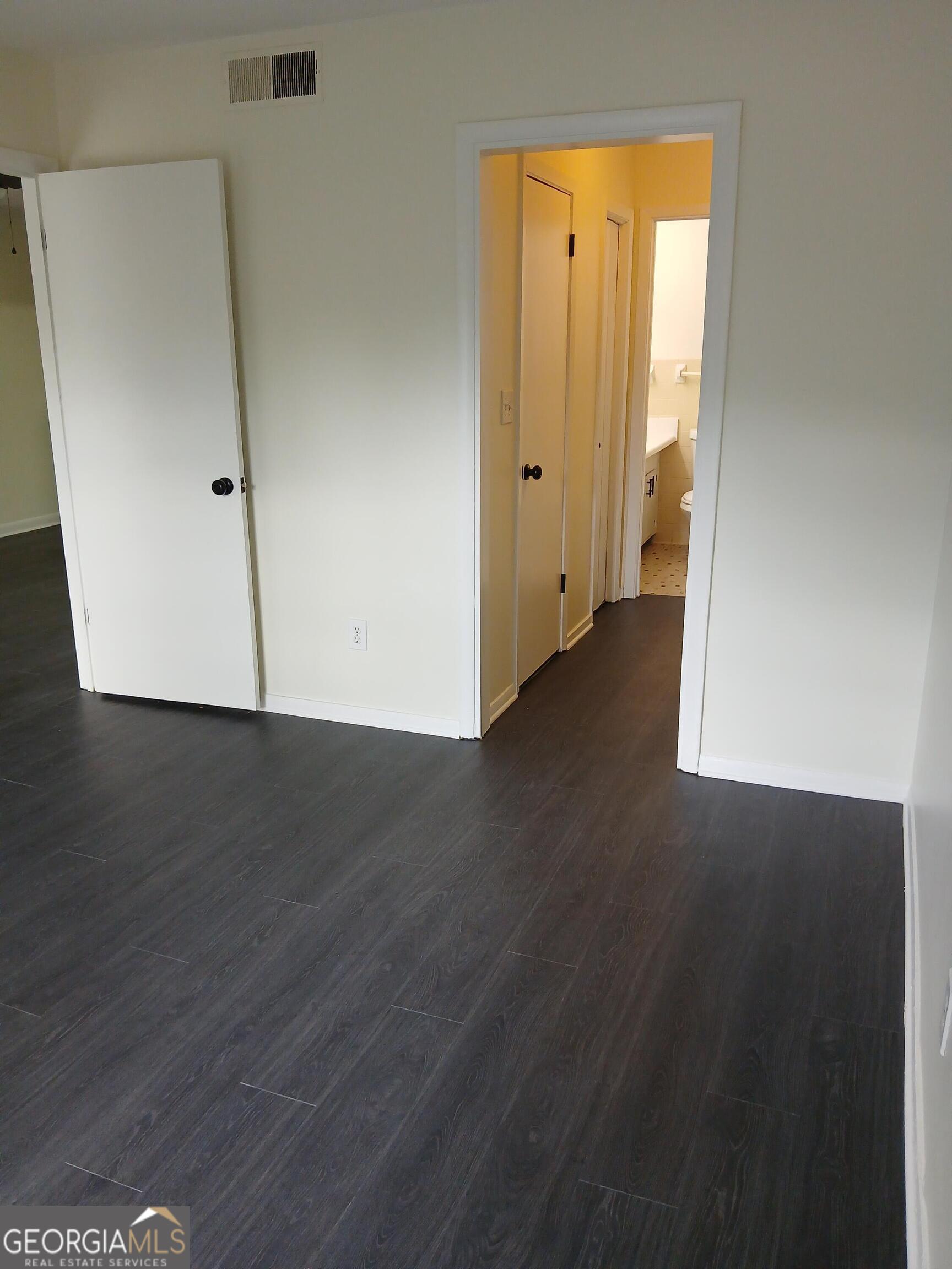 2805 Northeast Expressway Northeast, Unit B18 Atlanta, GA 30345 - Photo 8 of 13 an empty room with wooden floor and windows