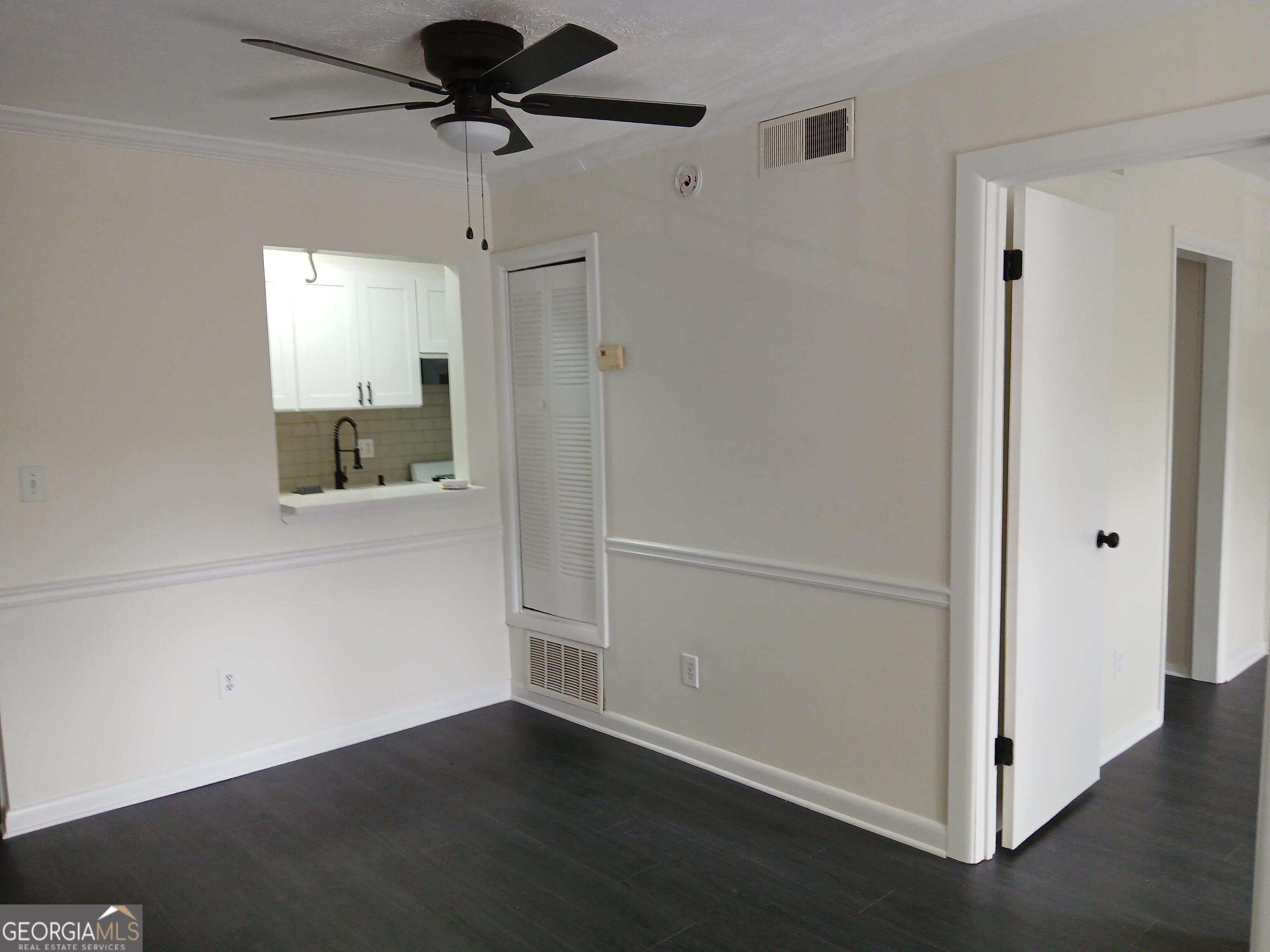 2805 Northeast Expressway Northeast, Unit B18 Atlanta, GA 30345 - Photo 10 of 13 a view of a hallway with wooden floor and a chandelier fan