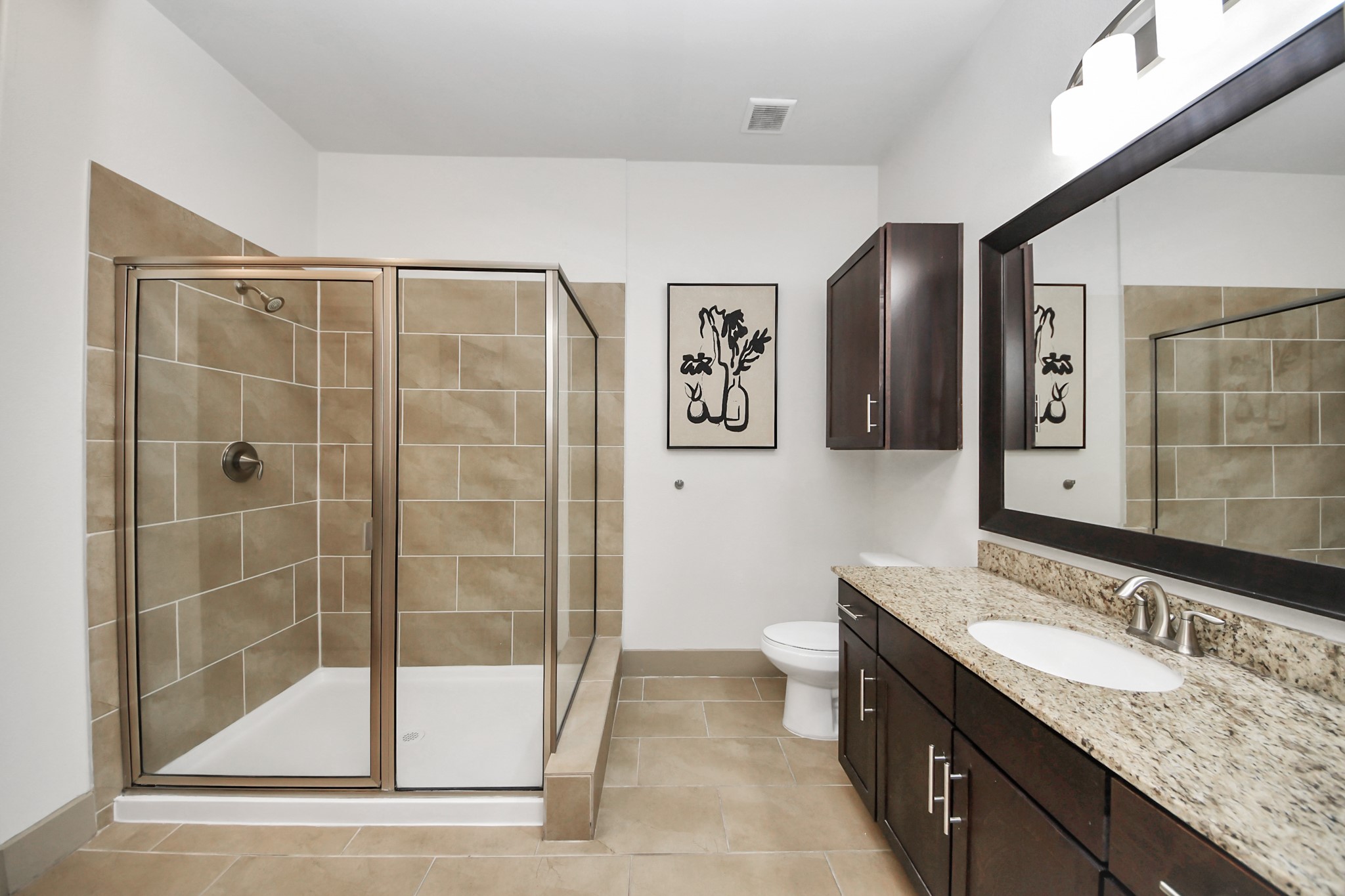 3800 Main Street, Unit 1 226 Houston, TX 77002 - Photo 44 of 50 a bathroom with a granite countertop sink a mirror and a shower