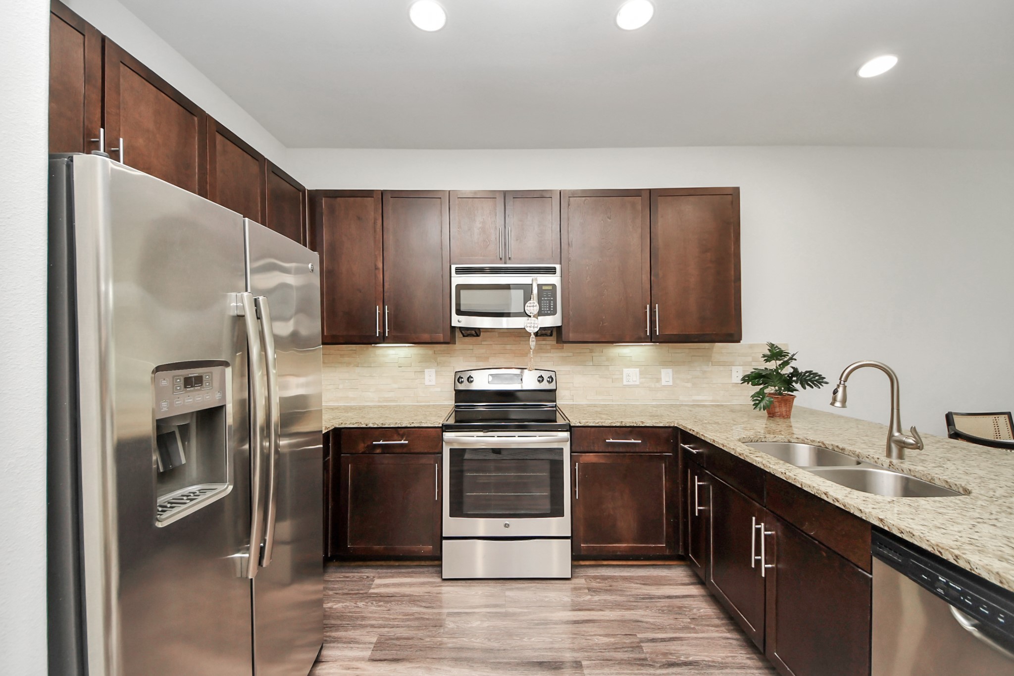 3800 Main Street, Unit 1 226 Houston, TX 77002 - Photo 47 of 50 a kitchen with stainless steel appliances granite countertop a stove a sink and a refrigerator