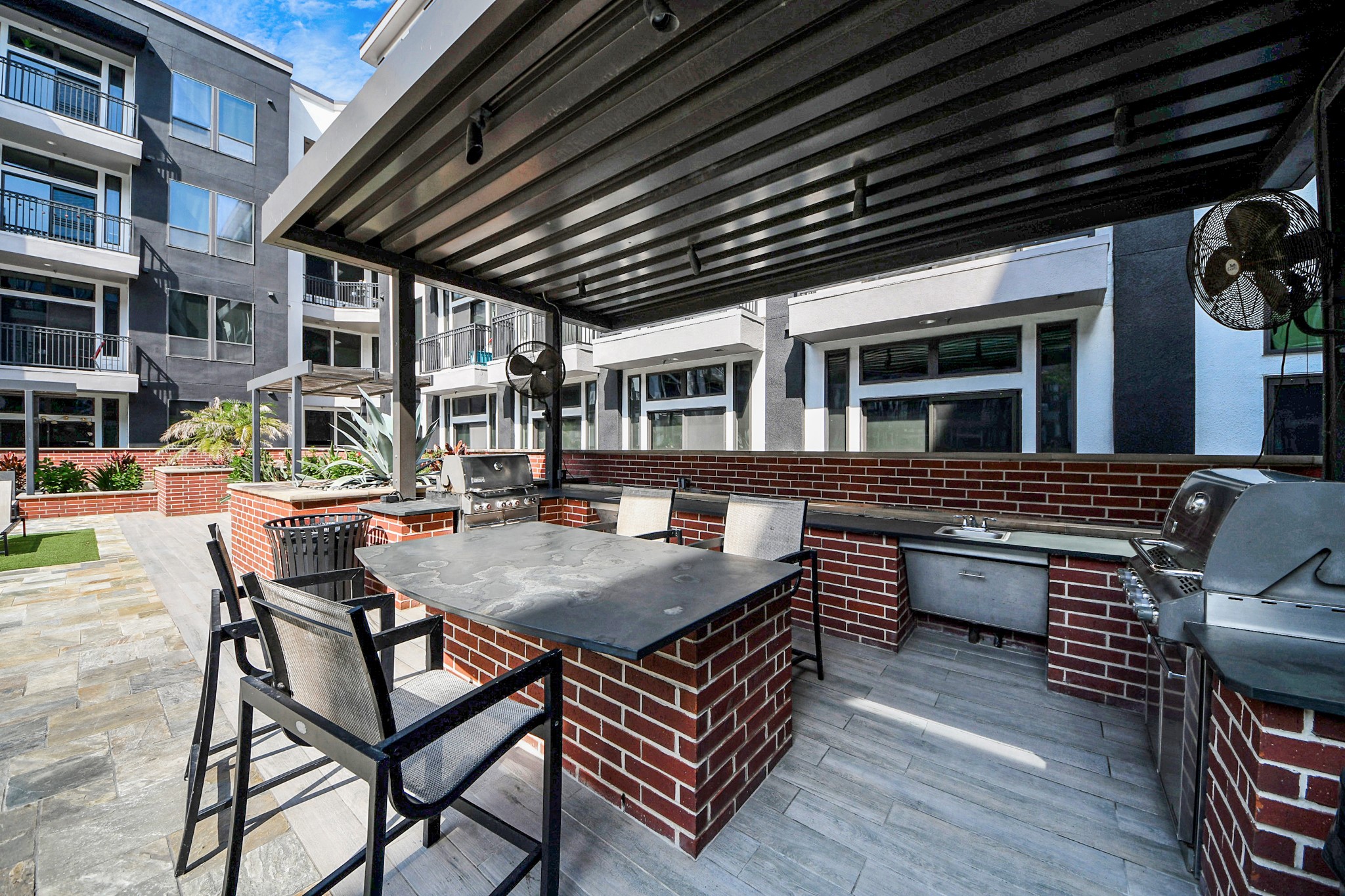 3800 Main Street, Unit 1 226 Houston, TX 77002 - Photo 50 of 50 a backyard of a house with barbeque oven table and chairs