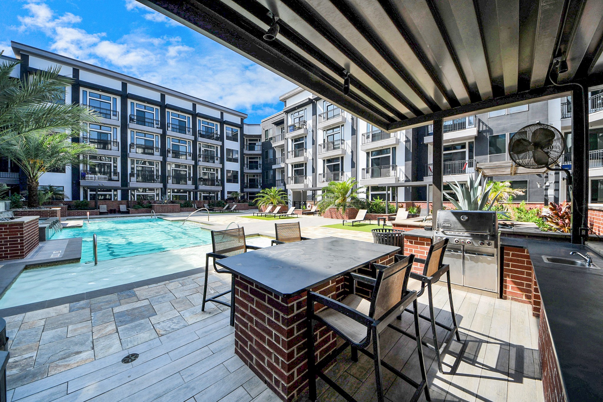 3800 Main Street, Unit 1 226 Houston, TX 77002 - Photo 2 of 50 a view of a patio with table and chairs and potted plants with wooden floor and fence