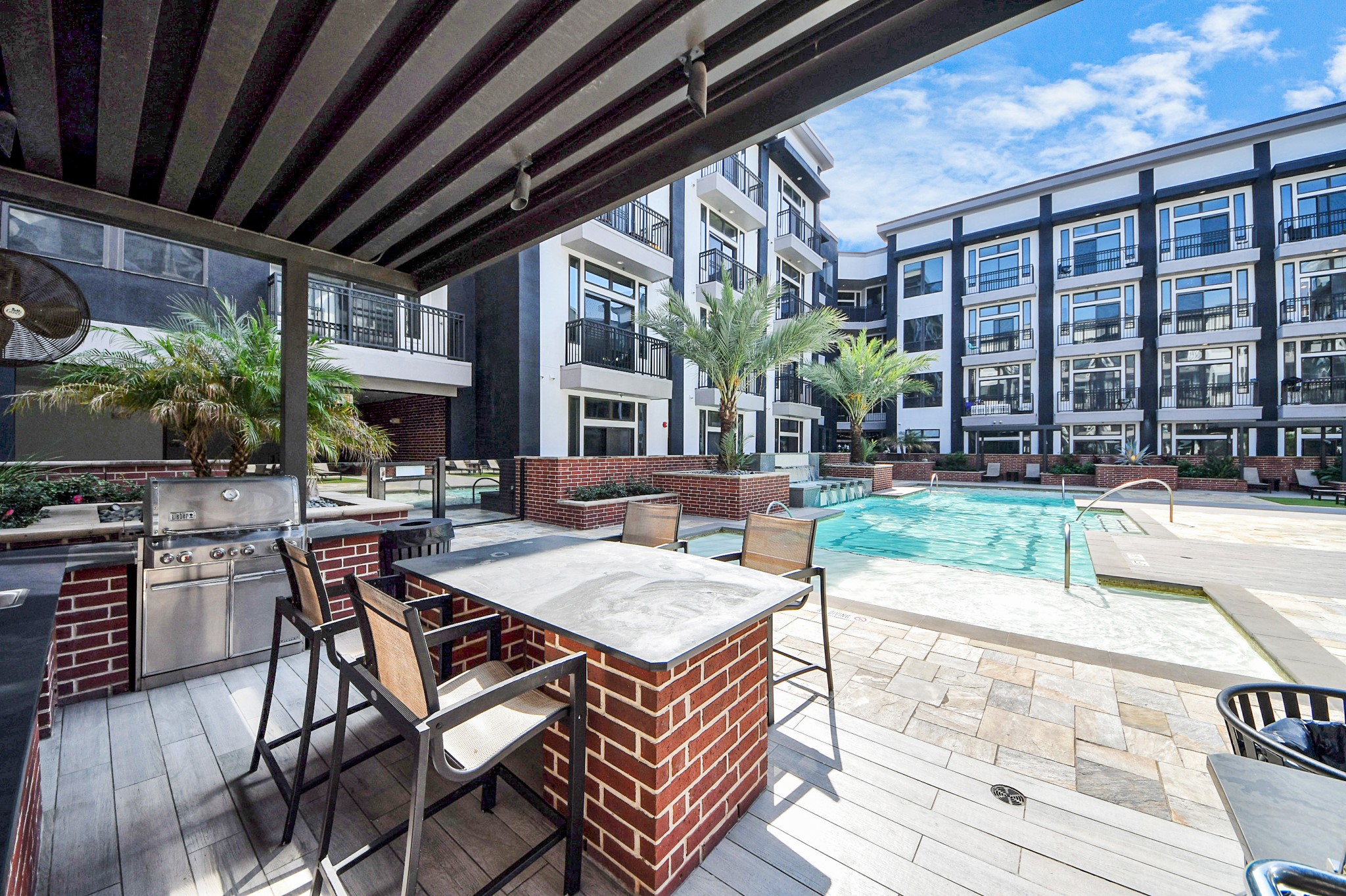 3800 Main Street, Unit 1 226 Houston, TX 77002 - Photo 3 of 50 a view of a patio with table and chairs potted plants and floor to ceiling window