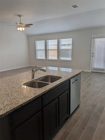 a sign board on a sidewalk next to a road