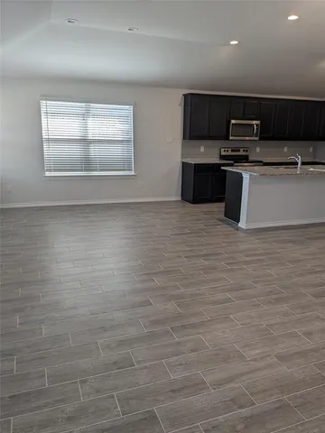 a kitchen with stainless steel appliances granite countertop a sink and a stove