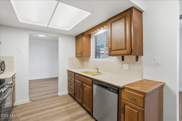 a kitchen that has a sink and a stove in it