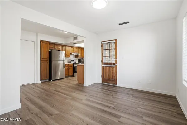 a view of a kitchen with a sink and refrigerator
