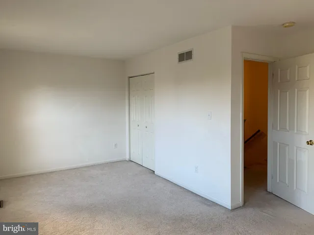a view of an empty room with a fireplace