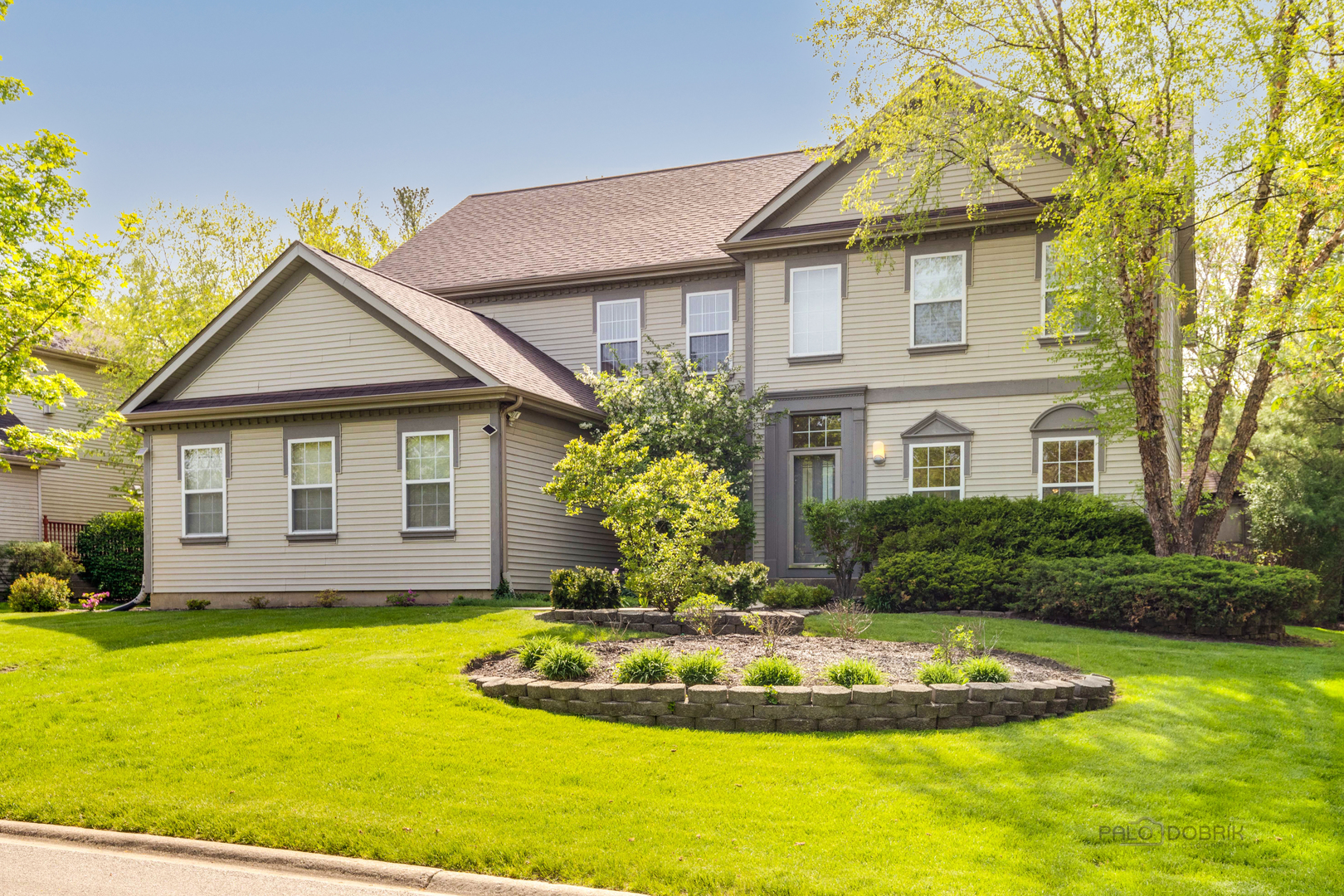 a front view of a house with a yard