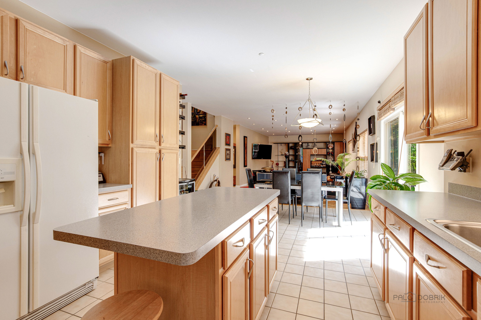 Undisclosed Address Long Grove, IL 60060 - Photo 13 of 35 a kitchen with stainless steel appliances a table chairs refrigerator and a sink
