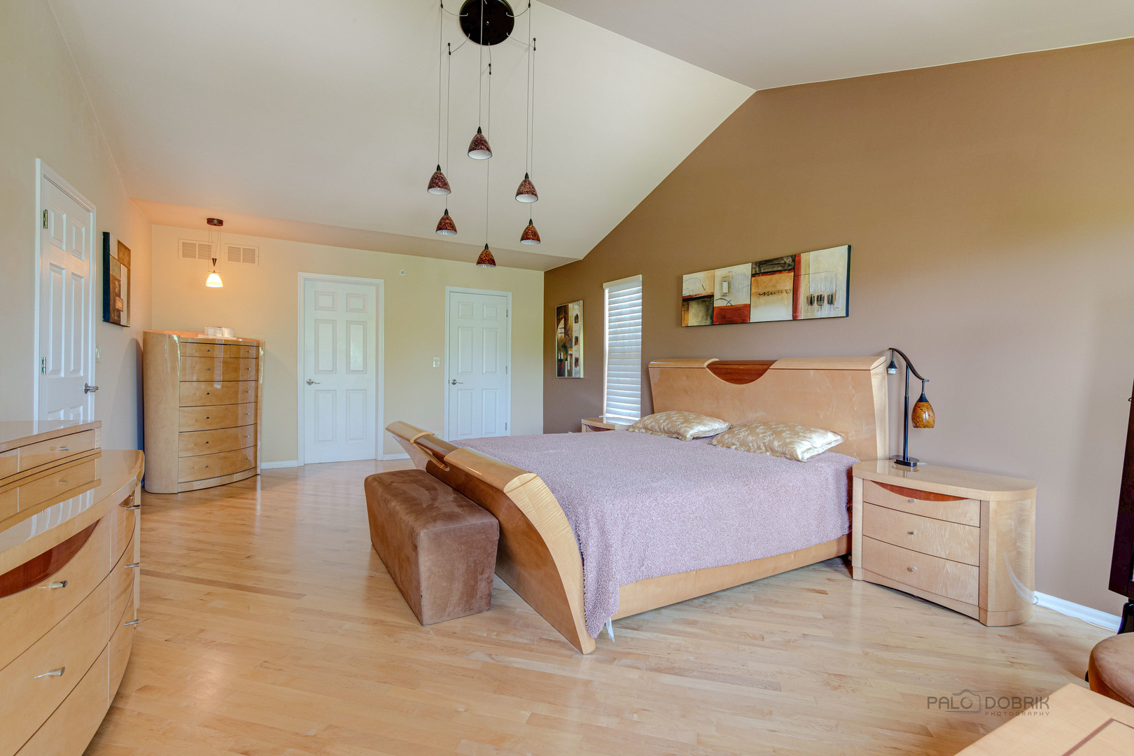 Undisclosed Address Long Grove, IL 60060 - Photo 18 of 35 a spacious bedroom with a bed and a chandelier