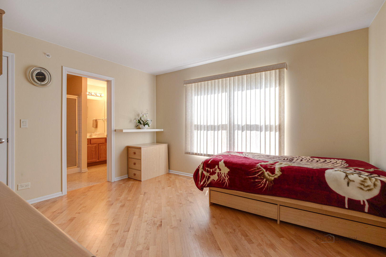 Undisclosed Address Long Grove, IL 60060 - Photo 26 of 35 a spacious bedroom with a bed and wooden floor