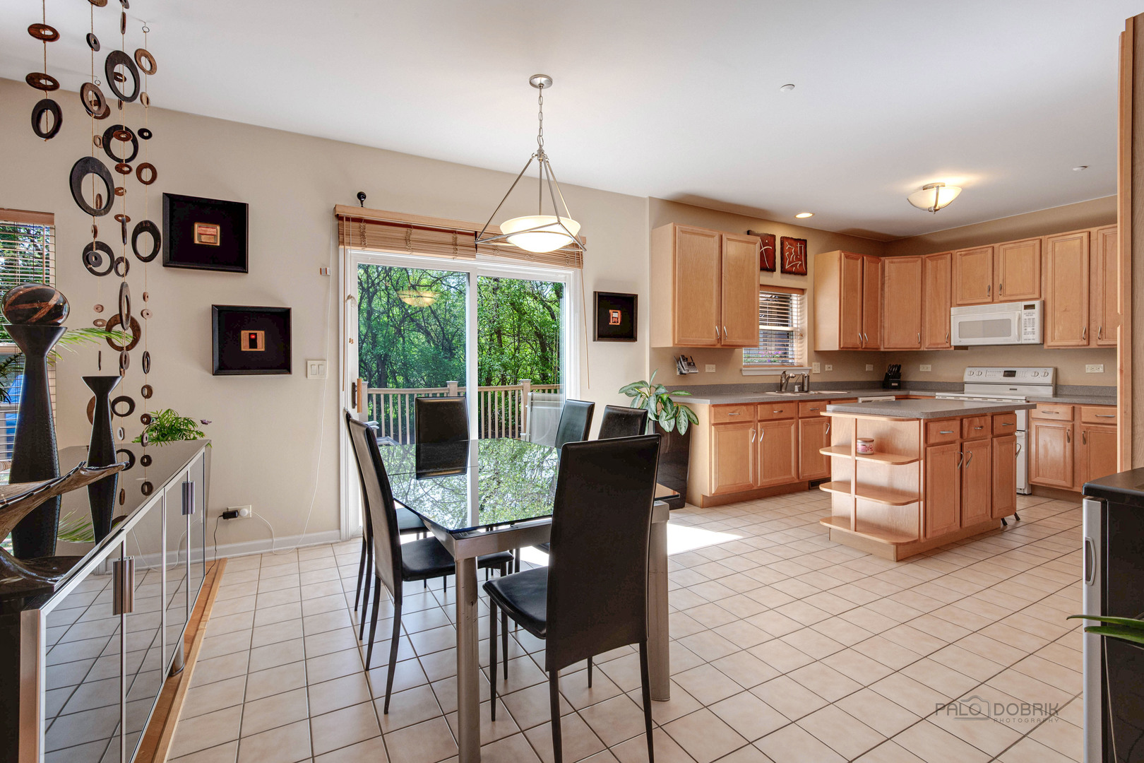 Undisclosed Address Long Grove, IL 60060 - Photo 6 of 35 a kitchen with stainless steel appliances granite countertop a stove a sink a microwave a dining table and chairs