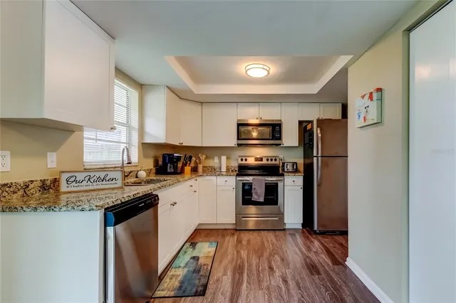 a kitchen with stainless steel appliances a refrigerator stove and sink