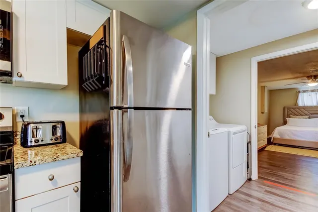 a kitchen with a refrigerator and cabinets