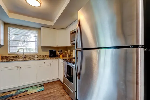 a kitchen with stainless steel appliances a refrigerator sink and cabinets