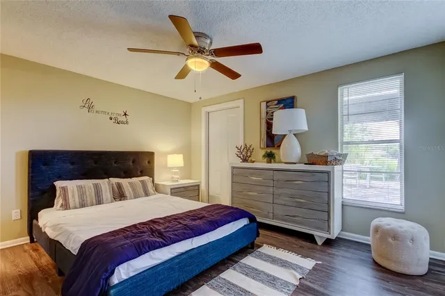 a bedroom with a large bed and chandelier