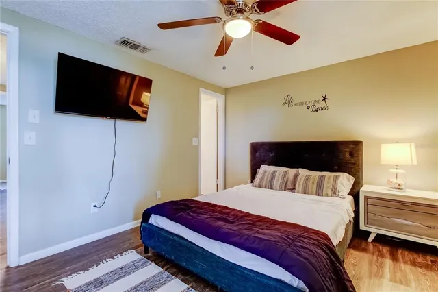 a bedroom with a bed and a flat screen tv