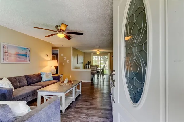 a living room with furniture a flat screen tv and a wall painting