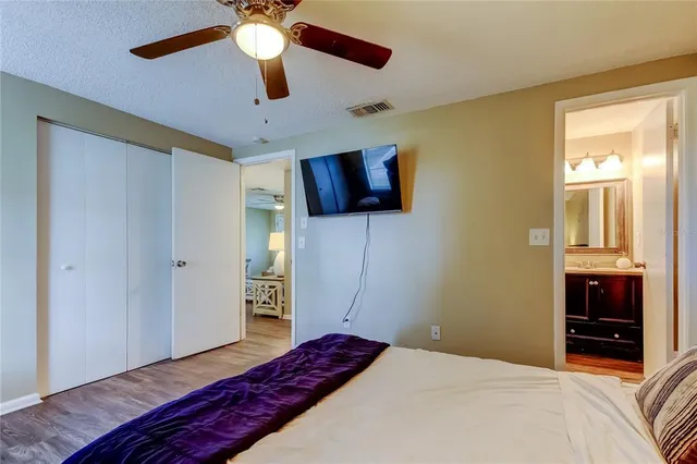 a bedroom with a bed and a television