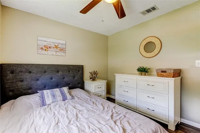 a spacious bedroom with a bed and a dresser