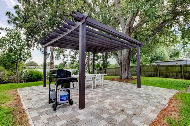 a view of a patio with a table chairs and a backyard