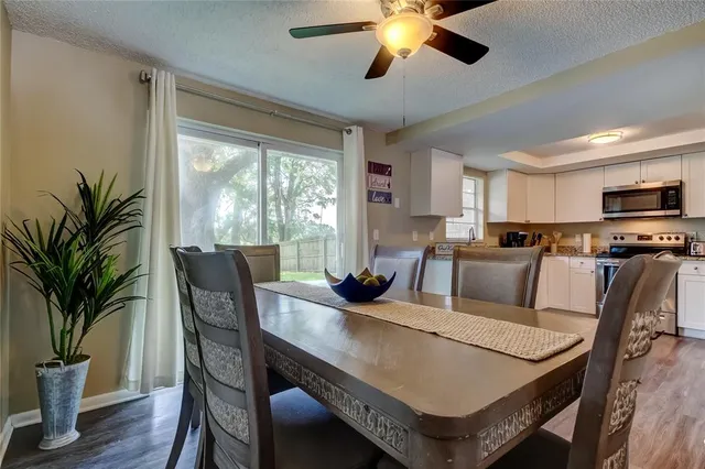 a view of a dining room with furniture window and wooden floor