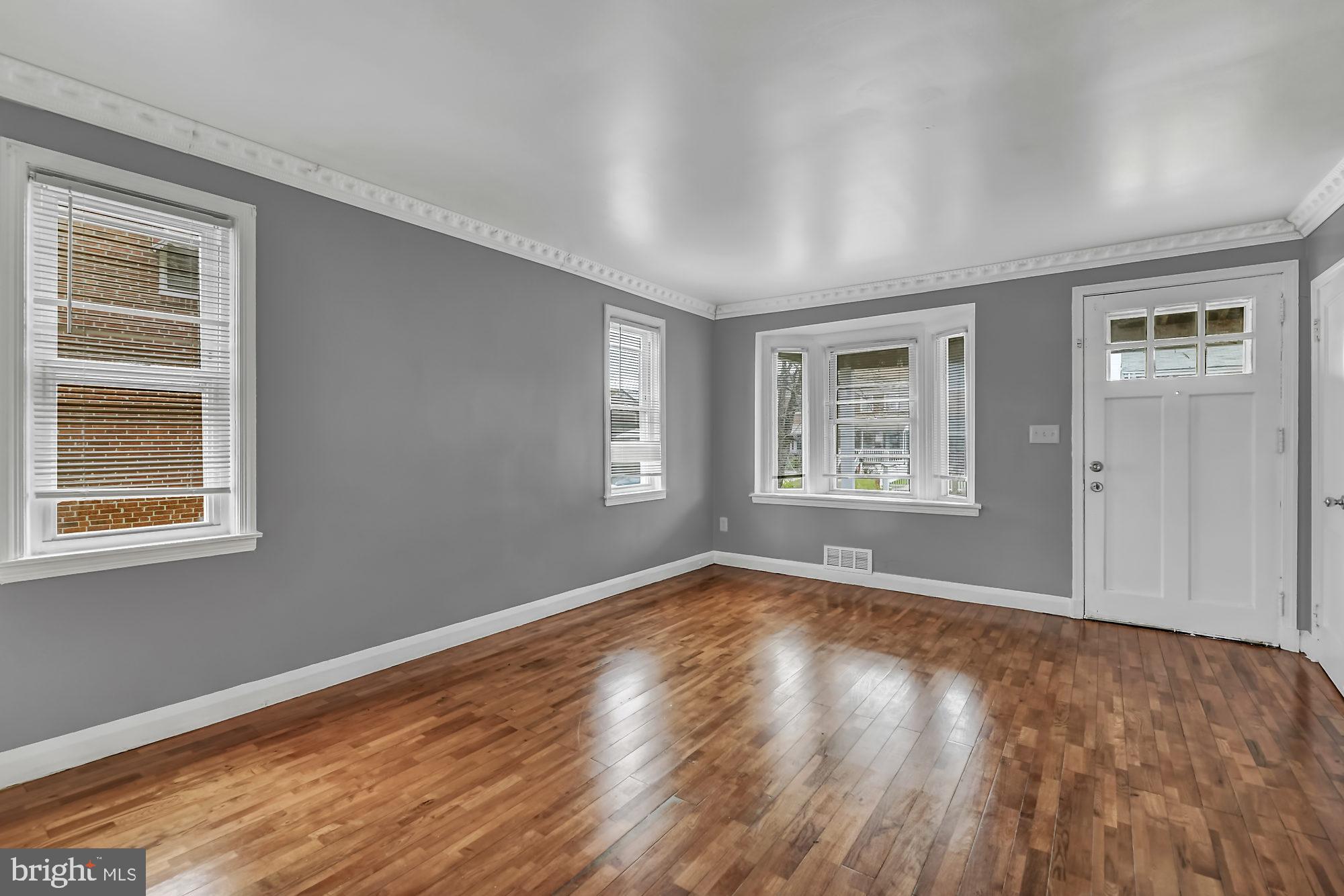 7921 Kavanagh Road Baltimore, MD 21222 - Photo 3 of 28 Living room with hardwood flooring & fresh paint