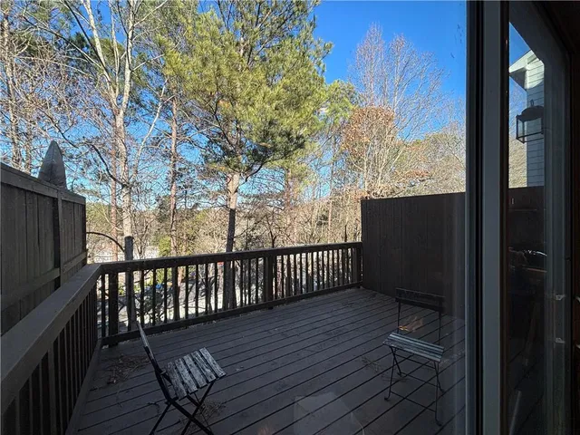 a view of a wooden chairs on the deck