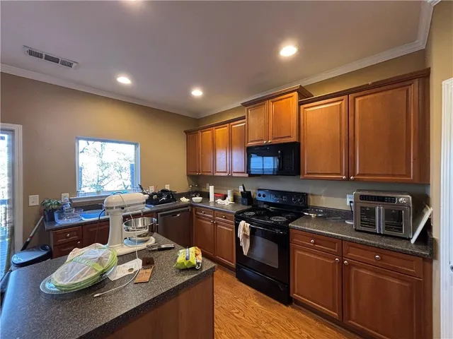 a kitchen with granite countertop lots of counter top space appliances and cabinets