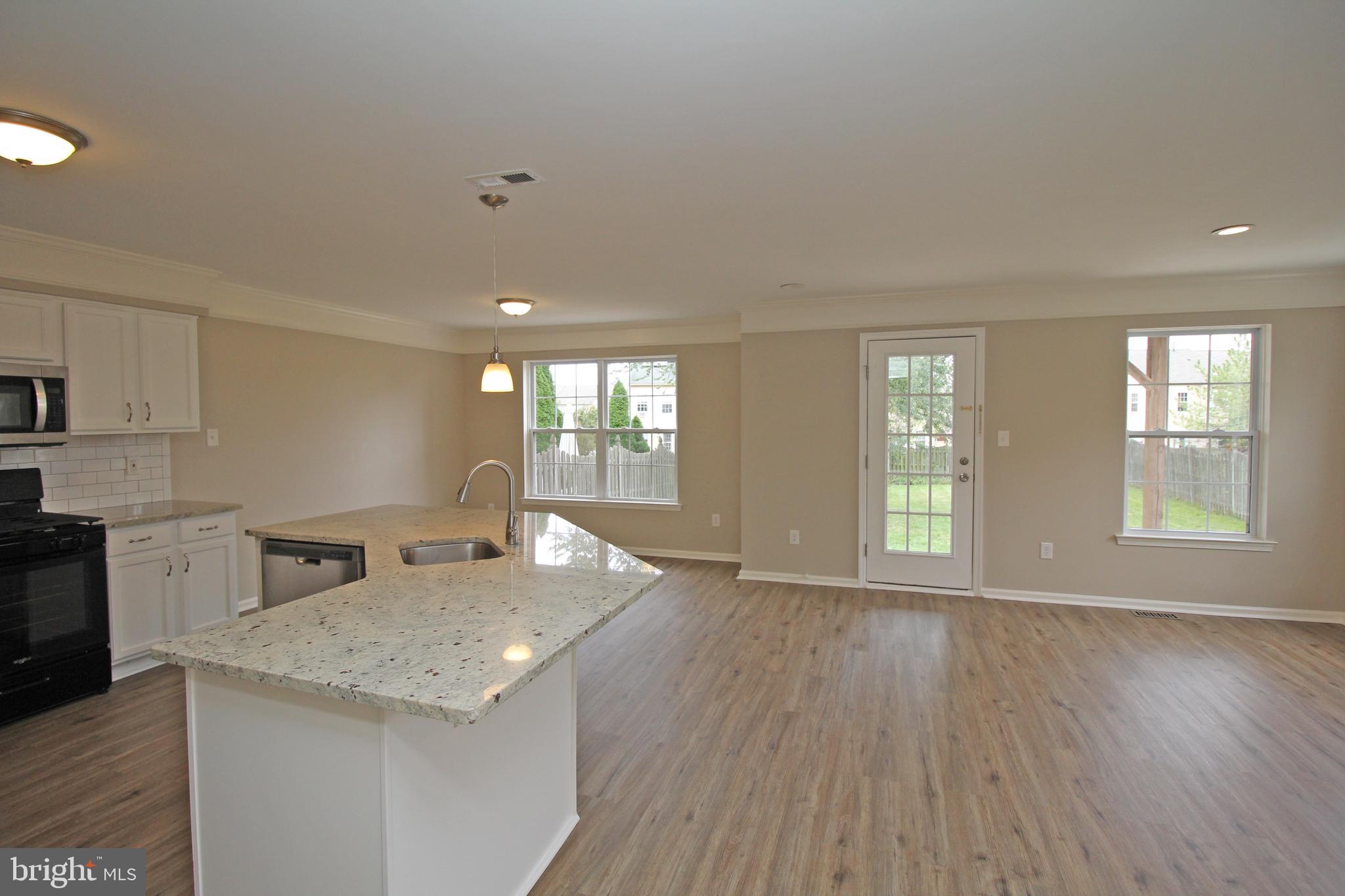 121 Wilson Lane Berlin, NJ 08009 - Photo 12 of 59 a kitchen with granite countertop a stove a sink a refrigerator and wooden floor