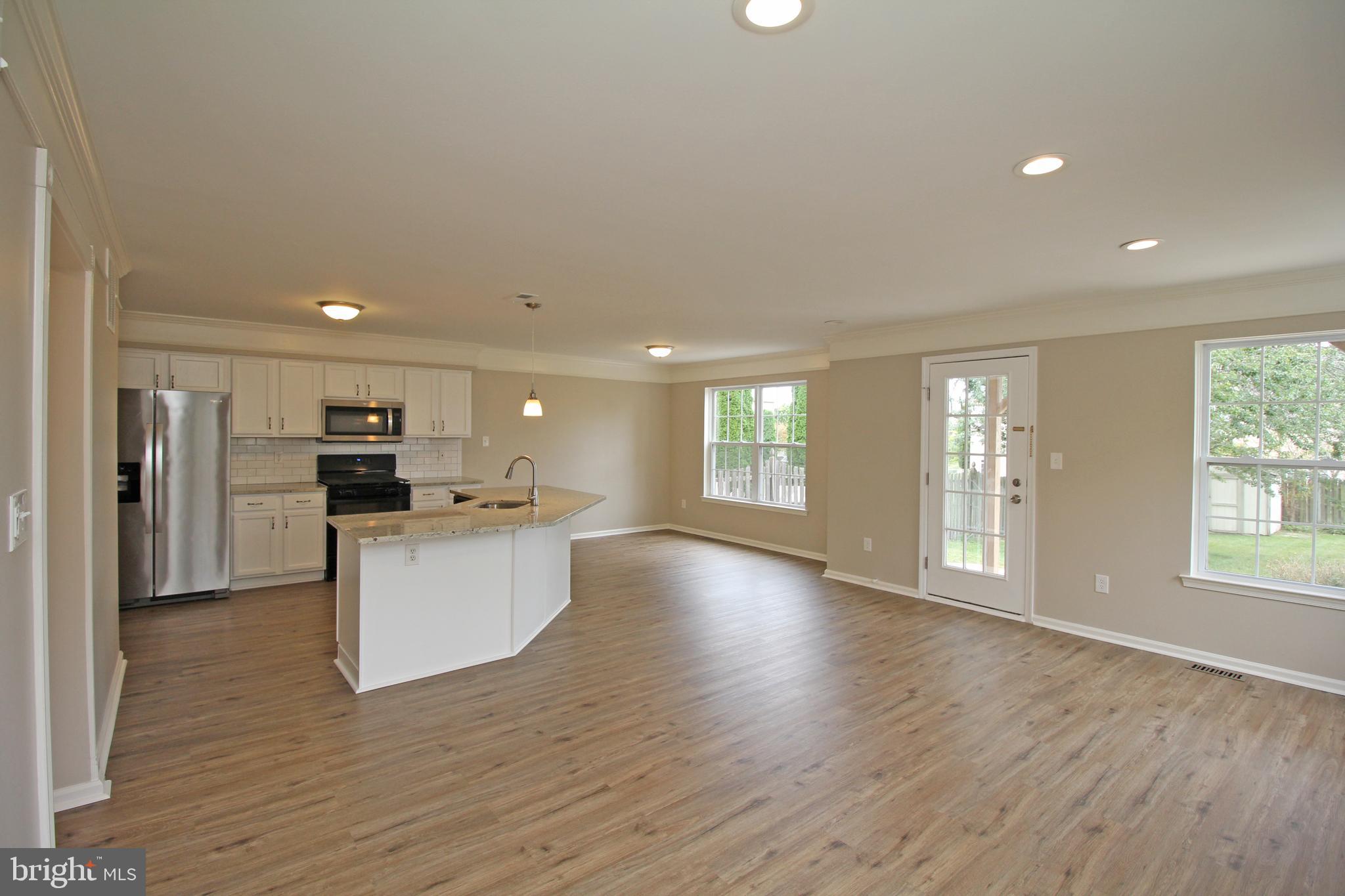 121 Wilson Lane Berlin, NJ 08009 - Photo 13 of 59 a view of kitchen with kitchen island wooden floor center island and stainless steel appliances